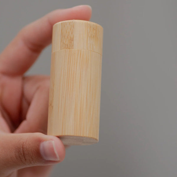 charcoal dental floss in a bamboo case.